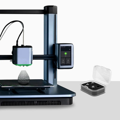 Built Tough Hardened Steel 3D Printer Nozzles 0.4mm Four Pack next to 3D printer with green LED display and printing model.