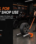 Heavy Duty Adjustable Tire Wheel Dolly With No Sweat Lever Lift Design And 440 Lbs Capacity For Effortless Hub Assembly Moving In Your Workshop and sturdy frame, black tire being moved by a man.