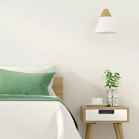 Minimalist bedroom with wooden nightstand and green accents
