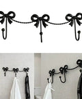 Kickass Heavy Duty Wall Mounted Coat Hook Bulletproof Metal Clothes Hanger with decorative bows in black for entryway use.