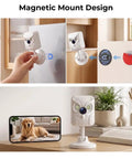 Crisp 2K Indoor Security Camera With Dual Band WiFi And Full Color Night Vision attached to a fridge with a dog visible on a smartphone.