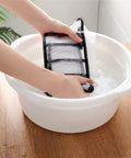 Washing a Slick Nylon Mesh Drawer Divider Set For Bras Socks And Lingerie Dresser Sorting Bins in a bowl of water.