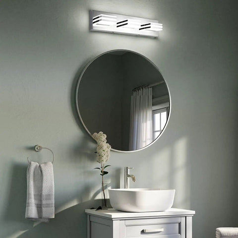 Wall-mounted 20 Inch LED Vanity Light Bar above round mirror in bathroom, 3 Light Chrome Fixture, 18W, 6000K Daylight LED Lighting.