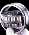 Heavy Duty Self Aligning Spherical Roller Bearings Rock Solid For Tough Industrial Machinery And Conveyor Lines 40 Mm X 90 Mm X 23 Mm Premium Chrome Steel shown in hand.