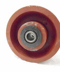 Bulletproof Four Inch Two Inch V Groove Caster Wheel With Seven Eighths Stem Crafted From Rugged Ductile Steel and Rollin Smooth On Heavy Duty Bearings For A Rock Solid One Five Zero Zero Pound Load Rating In Classic Burgundy, close-up view.