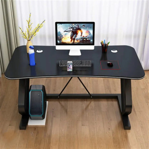 Solid Multifunction Computer Desk With Nifty Cable Management Hole Ergonomic Arched Edge Compact Gaming Workstation Total Game Changer For Tiny Rooms Waterproof Black Surface 47 Inches Wide, showcasing a black surface and accessories.