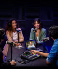 Killer Podcast Creator Kit Featuring Rodecaster Pro Two Mixing Board in use by four hosts with microphones and laptop.