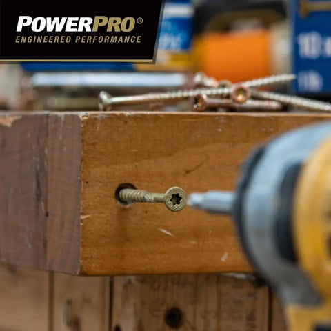 Premium Exterior Wood Screws For Decking And Outdoor Projects Built Tough Bronze Finish Size Nine By Two And A Half Inch All Purpose Deck Screws With T-25 Star Bit Included 100 Pack Epoxy Coated For Superior Corrosion Resistance being drilled into a wooden plank.