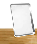 Heavy Duty Commercial 13 X 18 Half Size Aluminum Sheet Pan And Bun Tray With Sturdy Tapered Sides on wooden surface.