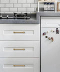Premium Solid Brushed Brass Cabinet Pulls And Drawer Handles 3 Inch Hole Center on white kitchen drawers.