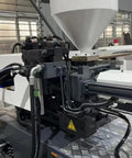 Close-up of Top Shelf Automatic Hydraulic Injection Molding Machine For Folding Plastic Chairs And Home Accessories showing hydraulic lines.