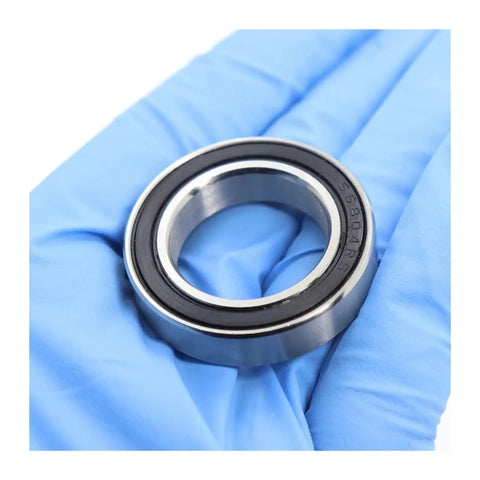 Nasty Smooth Hybrid Ceramic Ball Bearings With Rock Solid 440C Stainless Steel Rings For S6804 S6805 S6806 Models close-up in hand.