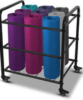 Rock Solid Black Yoga Mat Storage Rack With Smooth Rolling Wheels For Home Gym Studio Setup Holds Foam Rollers Resistance Bands And Straps Clean All Week Long, displaying colorful rolled mats.