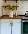 Six Pack Antique Brass Cabinet Cup Pulls Three Inch Center To Center Spacing on kitchen drawers with flowers and kitchenware.