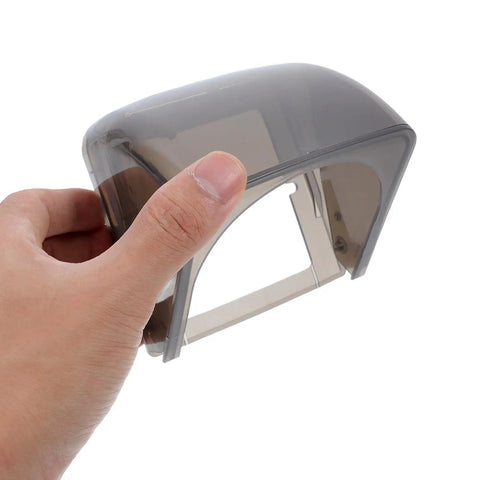 Hand holding a clear plastic Badass Wall Mount Outlet Cover Heavy Duty Waterproof Box For Ev Charge Stations.