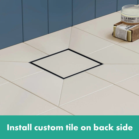 Square Tileable Shower Drain Set With Brushed Stainless Steel Construction And Flush Floor Mount Design For Modern Bathrooms featuring a square drain setup in a tiled floor.