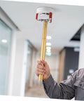 Heavy Duty Ceiling Detector Removal Tool With Badass Rubberized Claw And Extendable Aluminum Shaft held above a ceiling sensor.