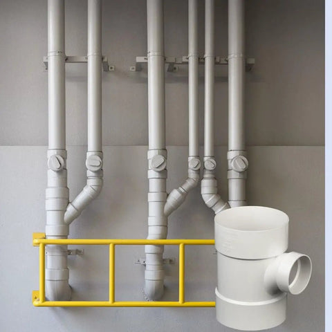 PVC DWV Sanitary Reducer Tee 4 By 4 By 2 Inch for drain waste and vent white plumbing fitting next to a piping system