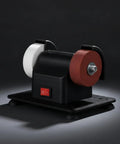 Compact Bench Top Grinder With Rock Solid Base Dual Sharpening Wheels, corded with black body and red/white wheels for home and light industry tasks.
