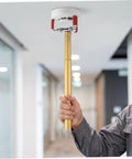 Ladder Free Smoke Sensor Removal Tool With 11 Point Eight Inch Extended Reach Stick being used to remove a high ceiling smoke detector