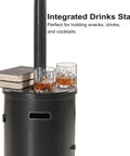 47000 BTU Outdoor Patio Heater With Round Table Design And Wheels Propane Gas Standing Heater shown with drink stand and glasses.