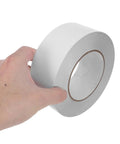Hella Strong Double Sided Adhesive Tape 5Cm X 164 Feet Pet Roll in hand, showcasing clear, heavy-duty tape for home projects.