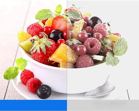 Bowl of mixed fruit salad with strawberries, raspberries, and mint leaves, vibrant colors, healthy snack option.
