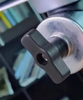 Close-up of 10 Pack Black M8 Through Hole T Knobs with plastic and copper design on machinery for quick release clamping.