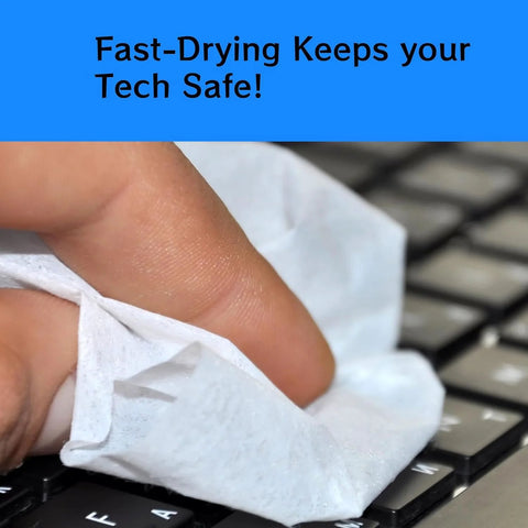 Close-up of a hand wiping a keyboard with a white cleaning towelette.