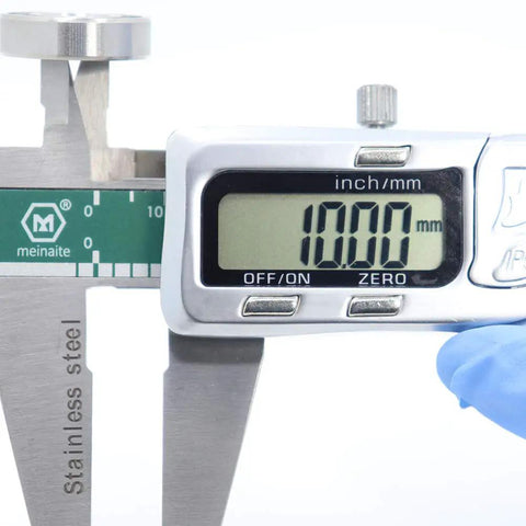 Measuring 10.00mm with digital calipers next to Four Pack 440C Stainless Steel Ball Bearings 10x22x6mm ABEC 3 Rubber Sealed.