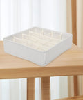 Sturdy Fabric Drawer Organizer Box With Segmented Compartments For Socks Underwear And Clothing Sorter Prime Home Setup on wooden table.