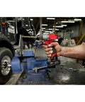 Built Tough Compact 1/2 Inch Cordless Drill Driver Kit in action, drilling metal with heavy-duty steel chuck in a workshop.