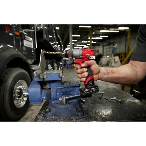 Built Tough Compact 1/2 Inch Cordless Drill Driver Kit in action, drilling metal with heavy-duty steel chuck in a workshop.
