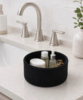 Super Handy Small Woven Cotton Rope Basket For Versatile Home Organization Black Storage Bin holding beauty products on a countertop.