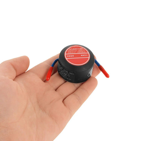 Slap This Auto Fire Suppressant Disc Straight Up On Dashboards Or Beneath Hood Panels Where Heat Spikes Triggers Instant Aerogel Burst to Snuff Blazes Quick Hardcore Aluminum Build For Rigs Boats And Trailers Hits Every Time You Expect, held in a hand.