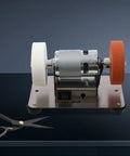 No Nonsense Mini Bench Grinder Rockin A Beefy 96W Copper Motor With Seven Smooth Variable Speeds From 3000 To 6000 Rpm Plus Easy Forward Reverse Controls For Quick Sharpening And Precision Grinding Work, featuring white and orange wheels.