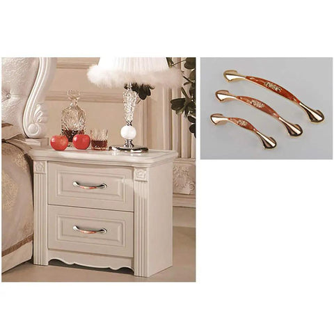Heavy Duty Zinc Alloy Cabinet Pulls And Drawer Knobs Knockout Amber Gold Finish on stylish nightstand with two drawers.