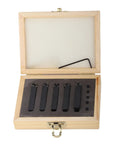 Carbide turning tool set in wooden box with five black blades and small inserts