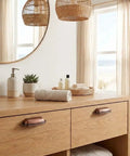 Premium 10 Pack Antique Copper Cup Pulls Three Inch Center To Center Solid Zinc Alloy Cabinet Handles on a wooden vanity.