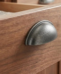 Close-up of Top Tier Weathered Nickel Cabinet Handles 25 Pack 3 Inch Hole Spacing, zinc pull on wooden drawer.
