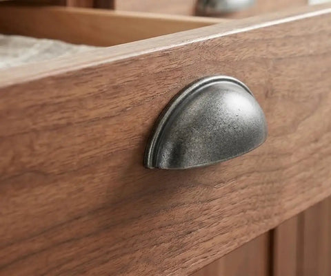 Solid As A Rock Weathered Nickel Cup Pull Handles on wooden drawer front, showcasing smooth grip and antique patina finish.