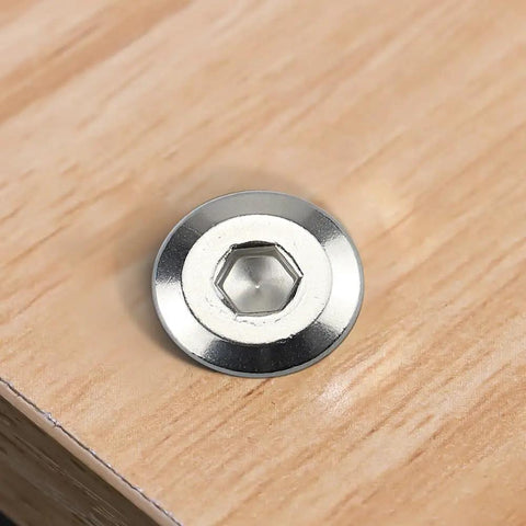 1/4 20 X 3/4 Inch Tough As Nails Furniture Connector Bolts And Barrel Nuts Kit showing a stainless steel hex nut on wood.