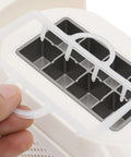 Fast Freeze Mini Countertop Ice Maker Features A Clear Viewing Lid while showing ice cube tray with white housing.