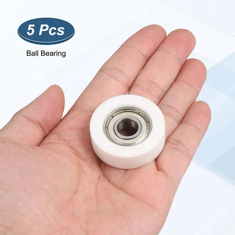 5 Pack Dead Silent Nylon Track Rollers With Rock Solid Precision Bearings 10mm Bore shown in hand with visible inner metal bearing.