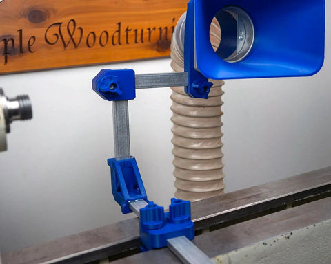 Kickass Adjustable Dust Collection Rig For Split Bed Wood Lathes With Tight Four Inch Hose Hookup and Three Way Flex Brackets for hassle free woodworking cleanup, blue flex arm.