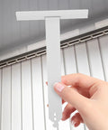 Heavy Duty Roller Shutter Hanger Strips With Pre Drilled Screw Holes And Snap Lock Slat Connector Clips Top Shelf Steel Hardware Kit, white steel part held in hand.