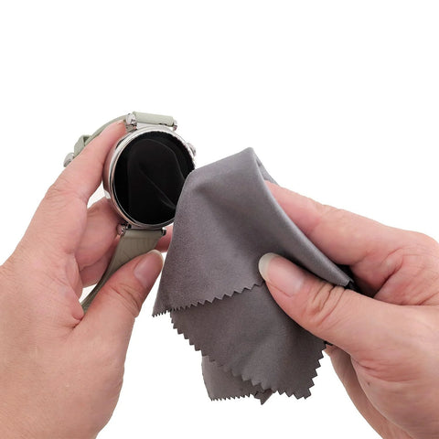 Xthel microfiber cleaning cloth for glasses and devices, gray, used to wipe a round smartwatch screen