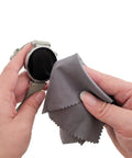 Xthel microfiber cleaning cloth, gray, close-up used to wipe a round smartwatch screen