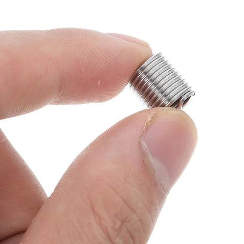 Close-up of a finger holding a stainless steel thread insert from the 10Pcs M8 Stainless Steel Thread Insert Kit For Quick Thread Repair And Maintenance