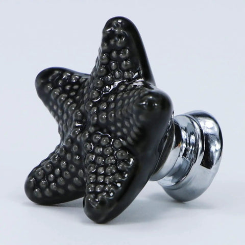 Upgrade Your Cabinets With These Badass Black Starfish Drawer Knobs Coastal Ceramic Cabinet Handles Fresh Ocean Themed Set close-up of black starfish knob.